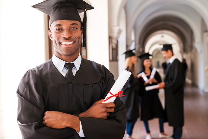 college graduate holding his diploma | Dean Team Subaru in Ballwin MO